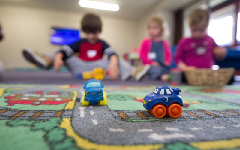 Kinder spielen im Kindergarten mit Spielzeugautos